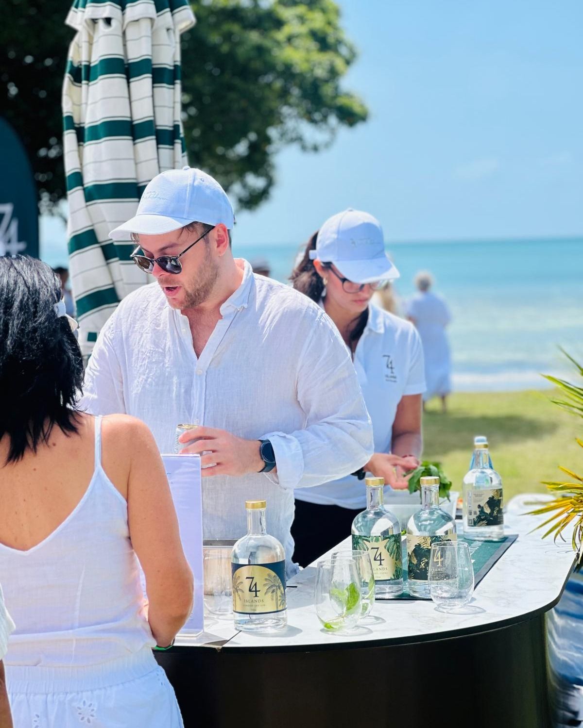 Jesse serving at a beach bar activation
